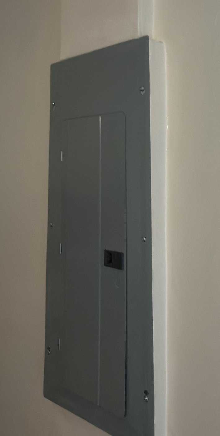 Electrical panel after drywall repair and paint by Lenix Home Services