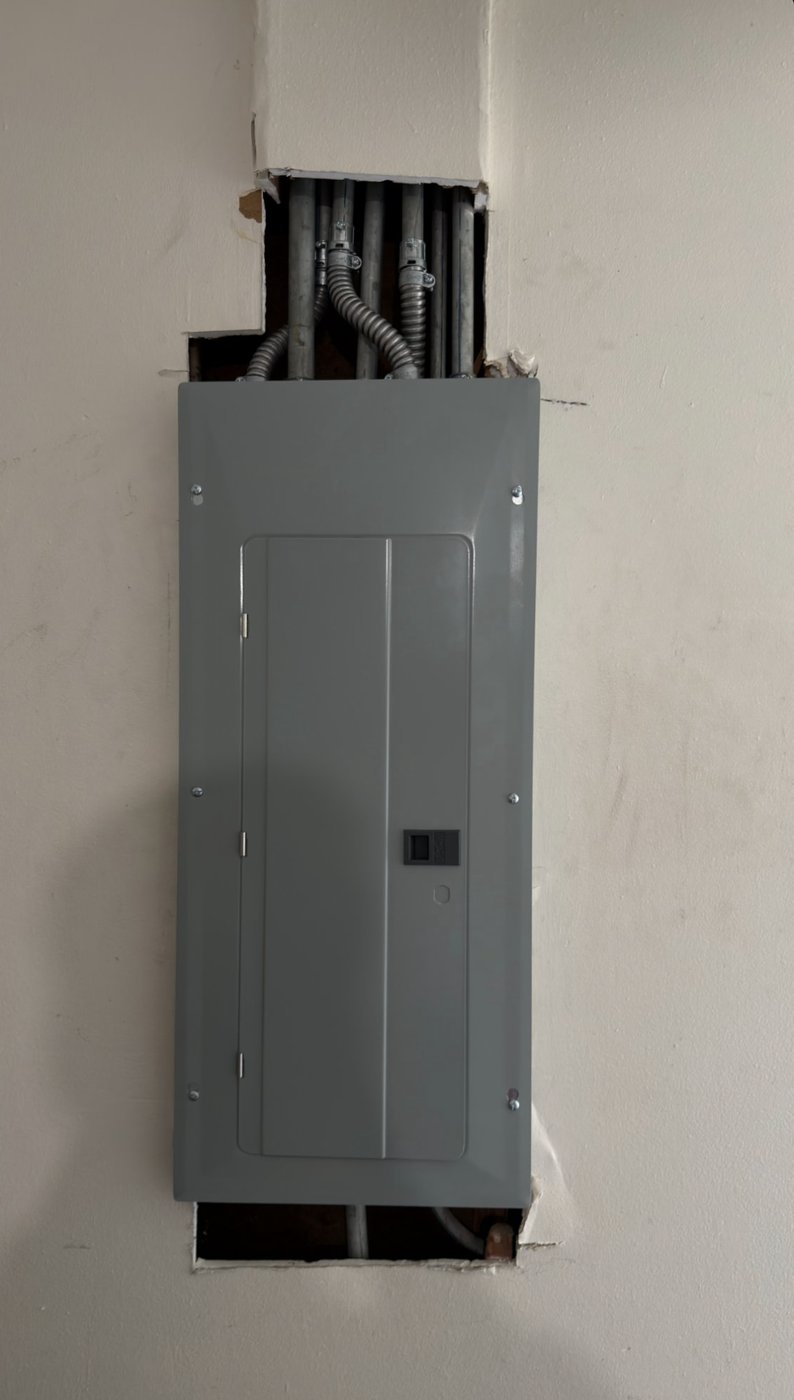 Electrical panel before drywall repair by Lenix Home Services